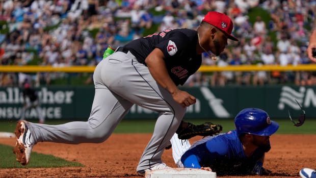 Mar 3, 2024; Mesa, Arizona, USA; Cleveland Guardians first baseman Deyvison De Los Santos (70) tags Chicago Cubs Joe Hudson (57) in the third inning at Sloan Park.